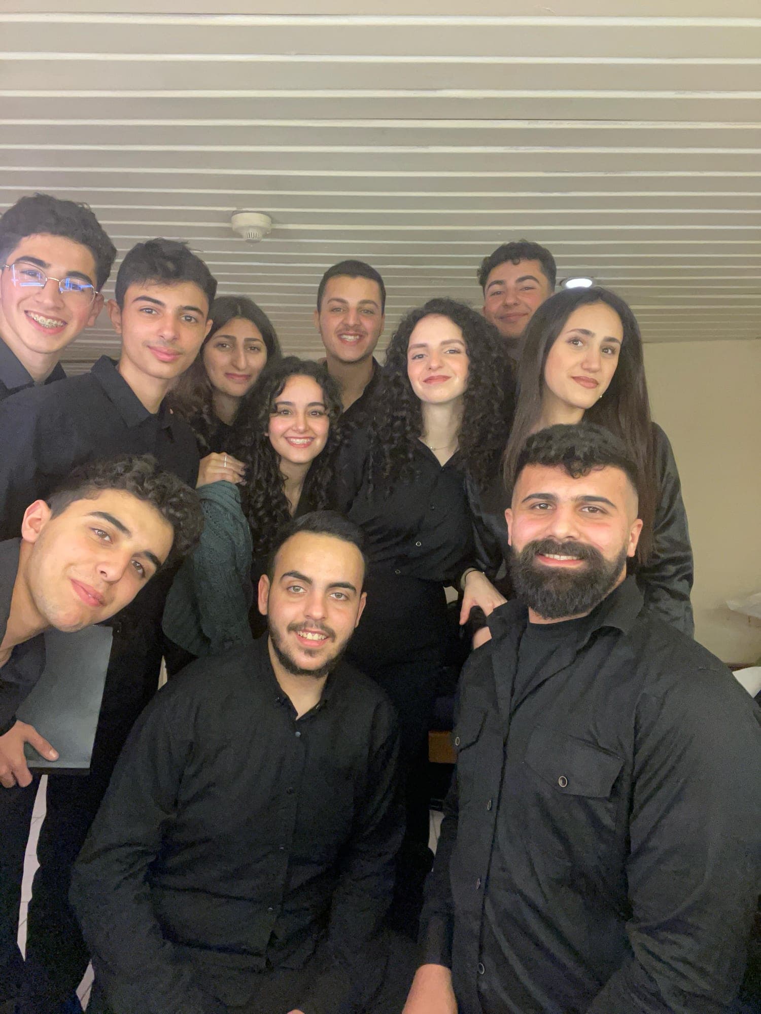Members smiling together backstage